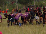 Two rugby league teams - one in purple and one team in black - playing a game